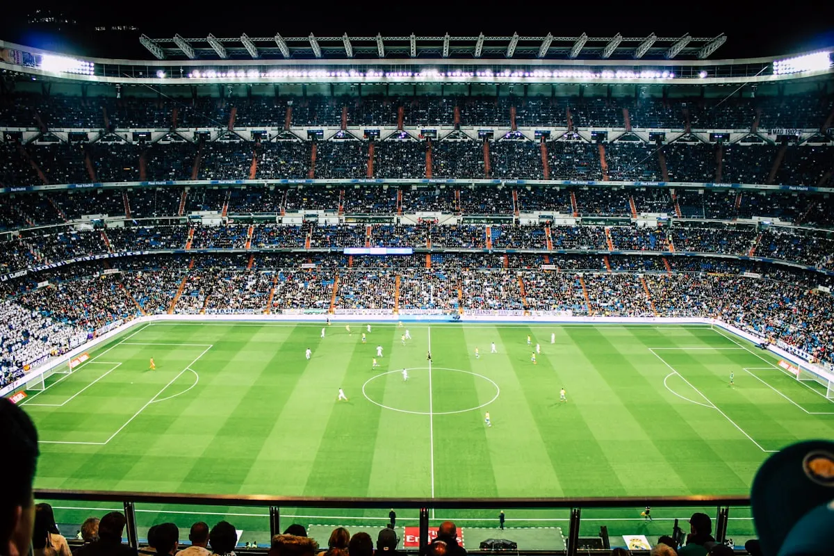 A full football stadium under floodlights during a match